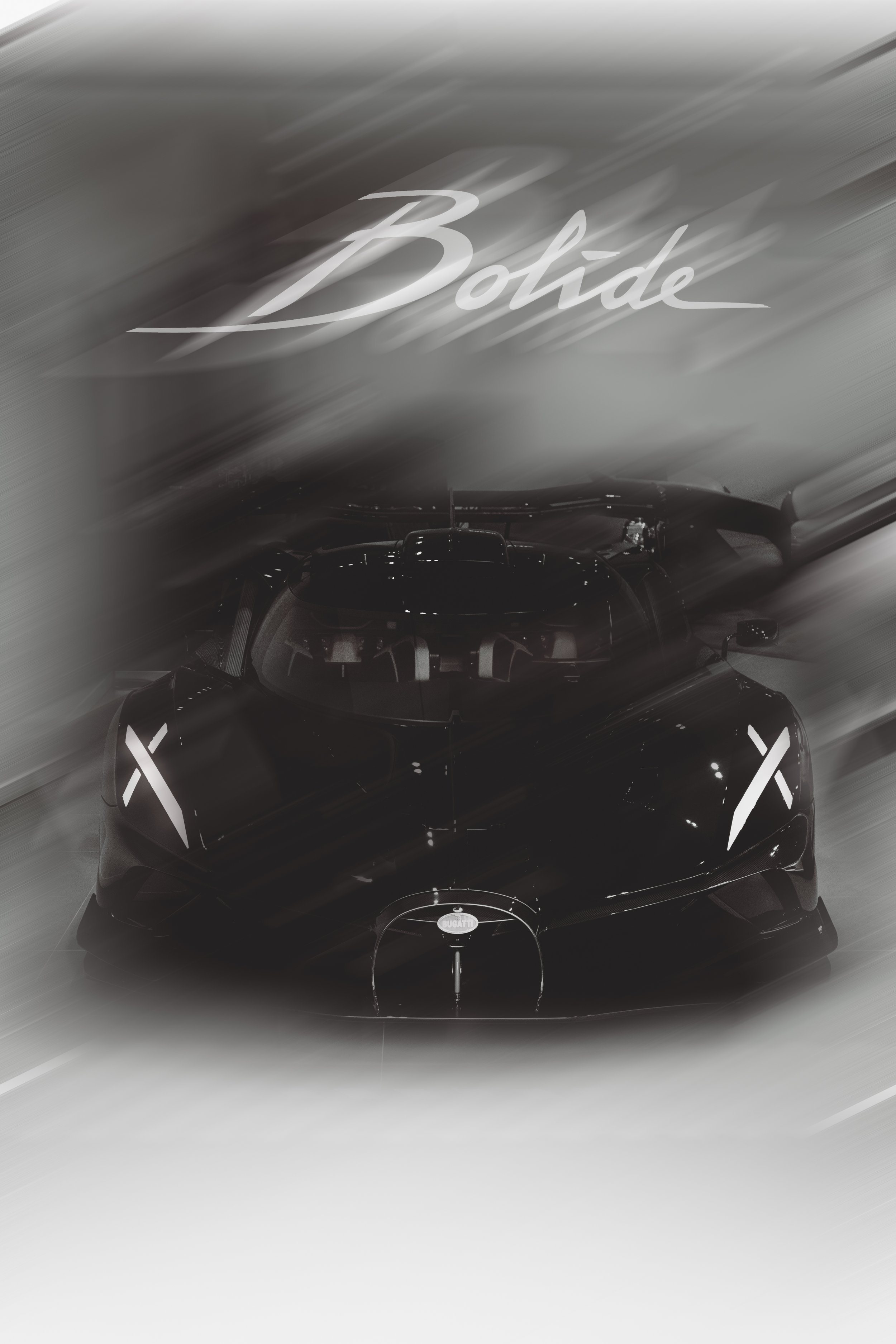 A black racing car, a Bugatti, on display at an auto show, with the word 'Bolide' written above it in cursive. The photo has a motion blur effect.